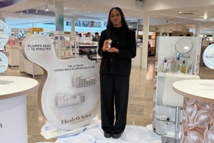 Temporary retail staff member, Victoria standing on counter at Elizabeth Arden in Arnotts Dublin